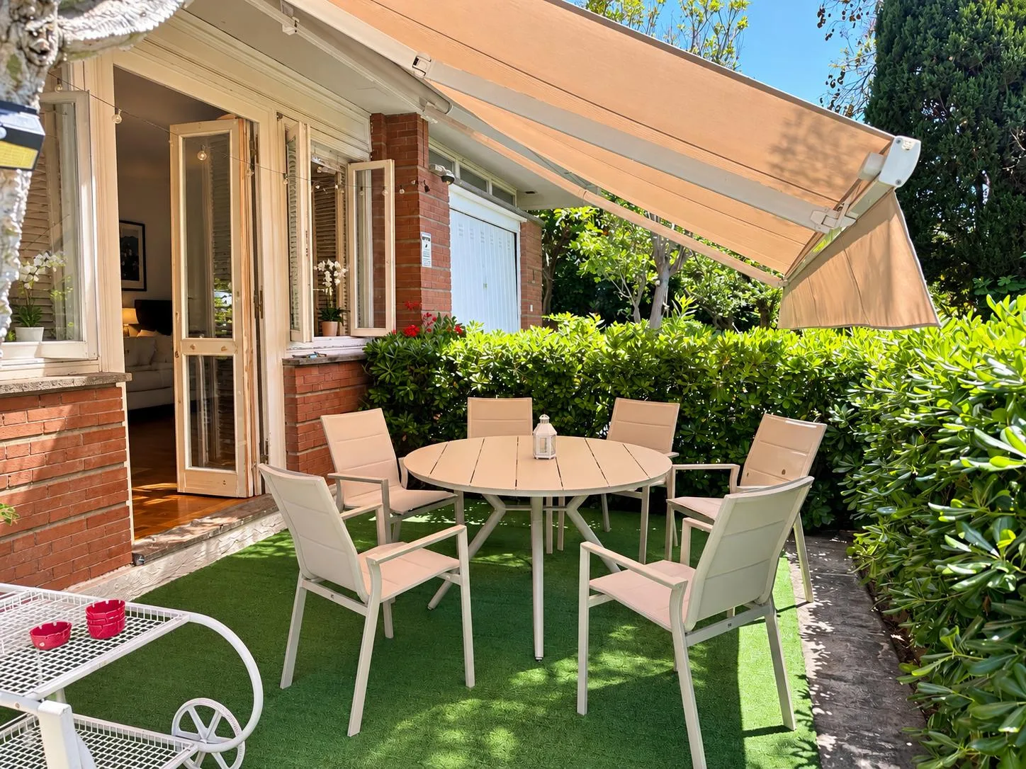 Table and chairs under the awning, next to the French doors onto the garden