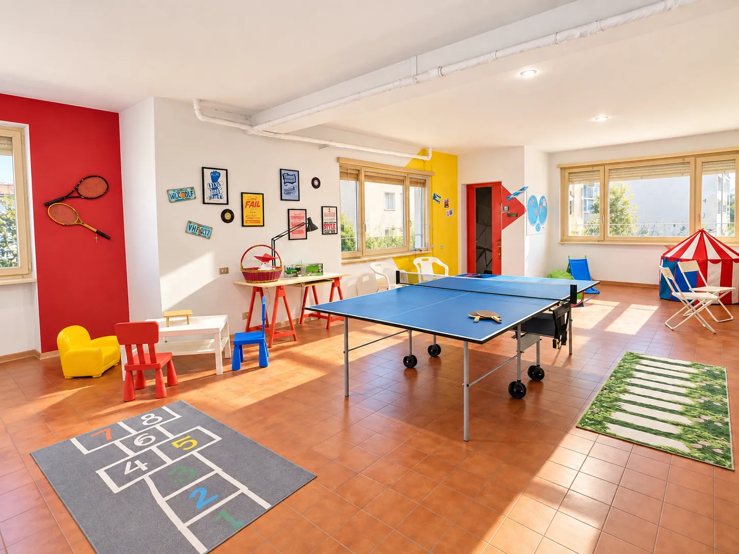 Bright games room with table tennis, rugs and colourful furniture