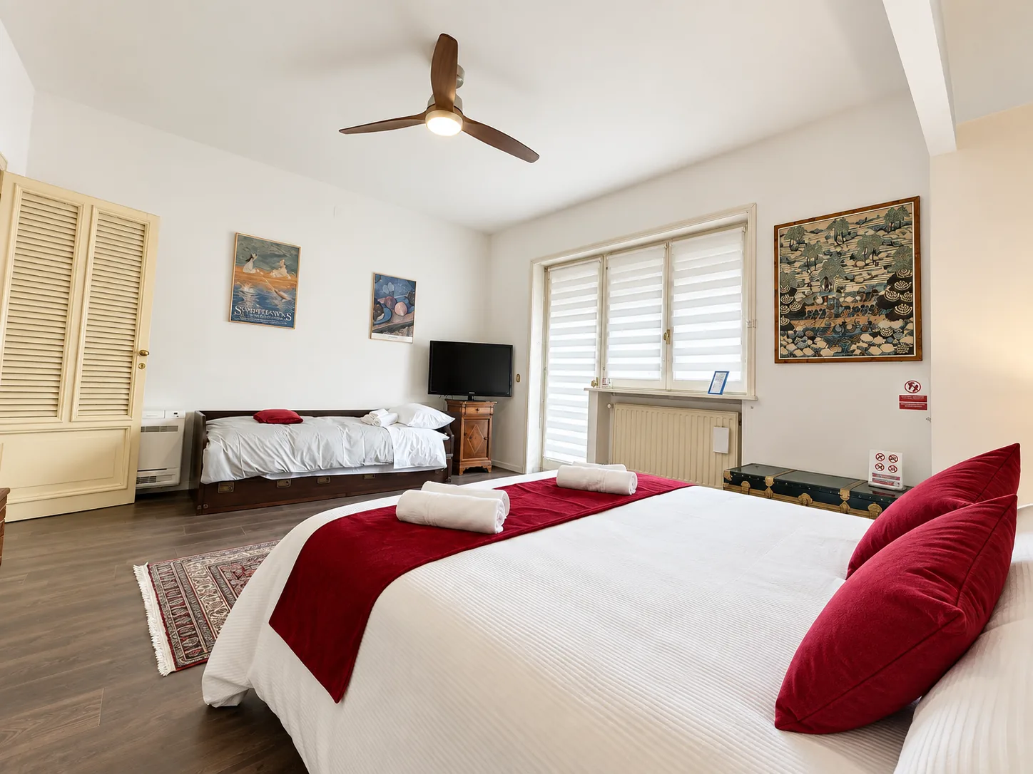 Overview of the Main Bedroom with daybed and television