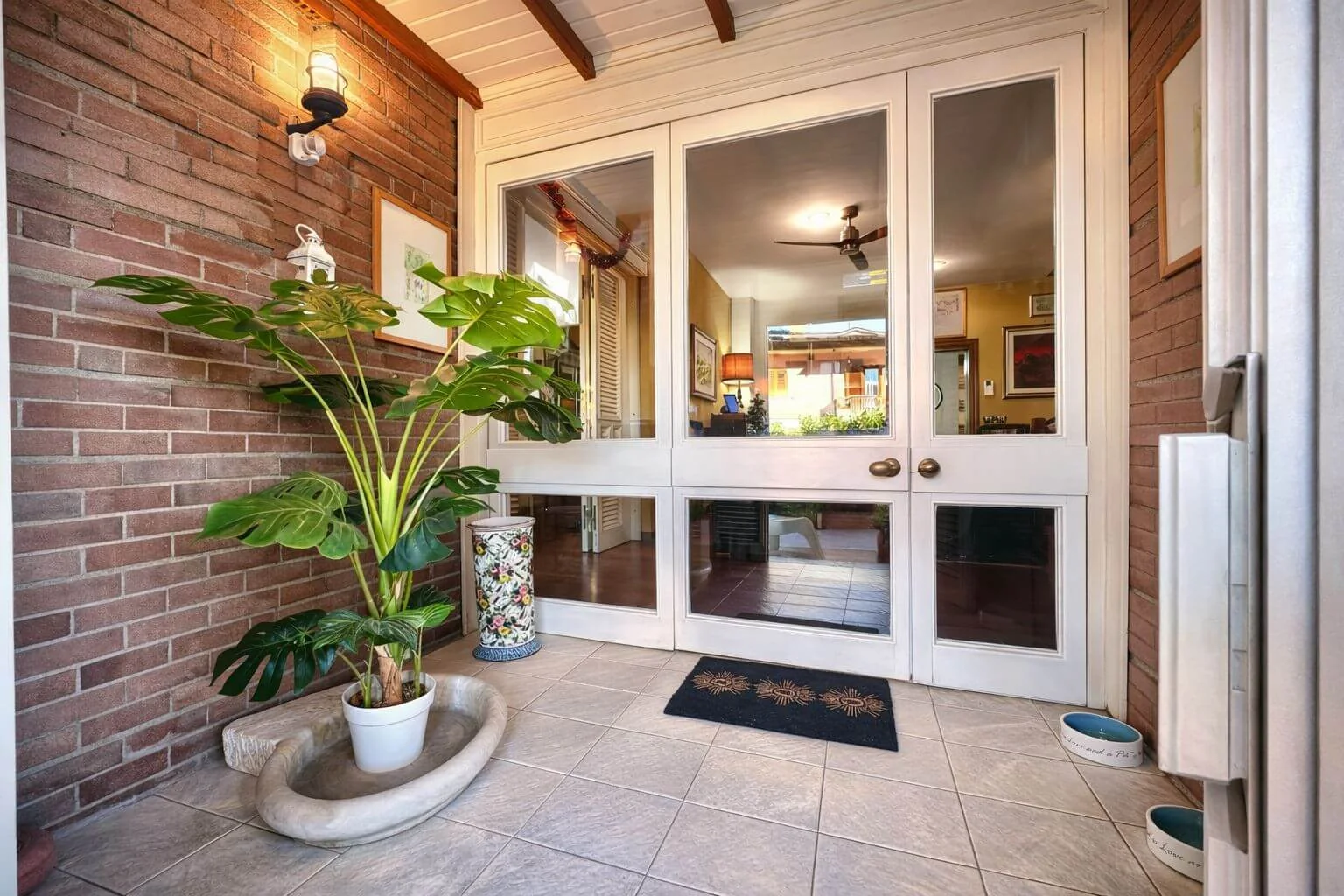 Entrance veranda with plants and glass doors